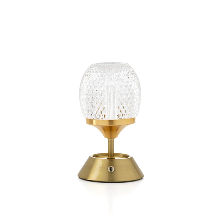 Decorative lamp with gold base and clear glass shade on a white background
