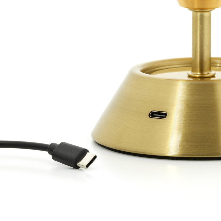 Gold lamp base with USB cable on a white background