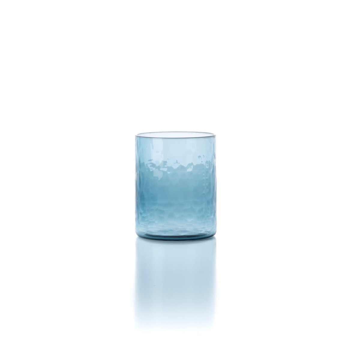 Blue glass tumbler with water on a white background