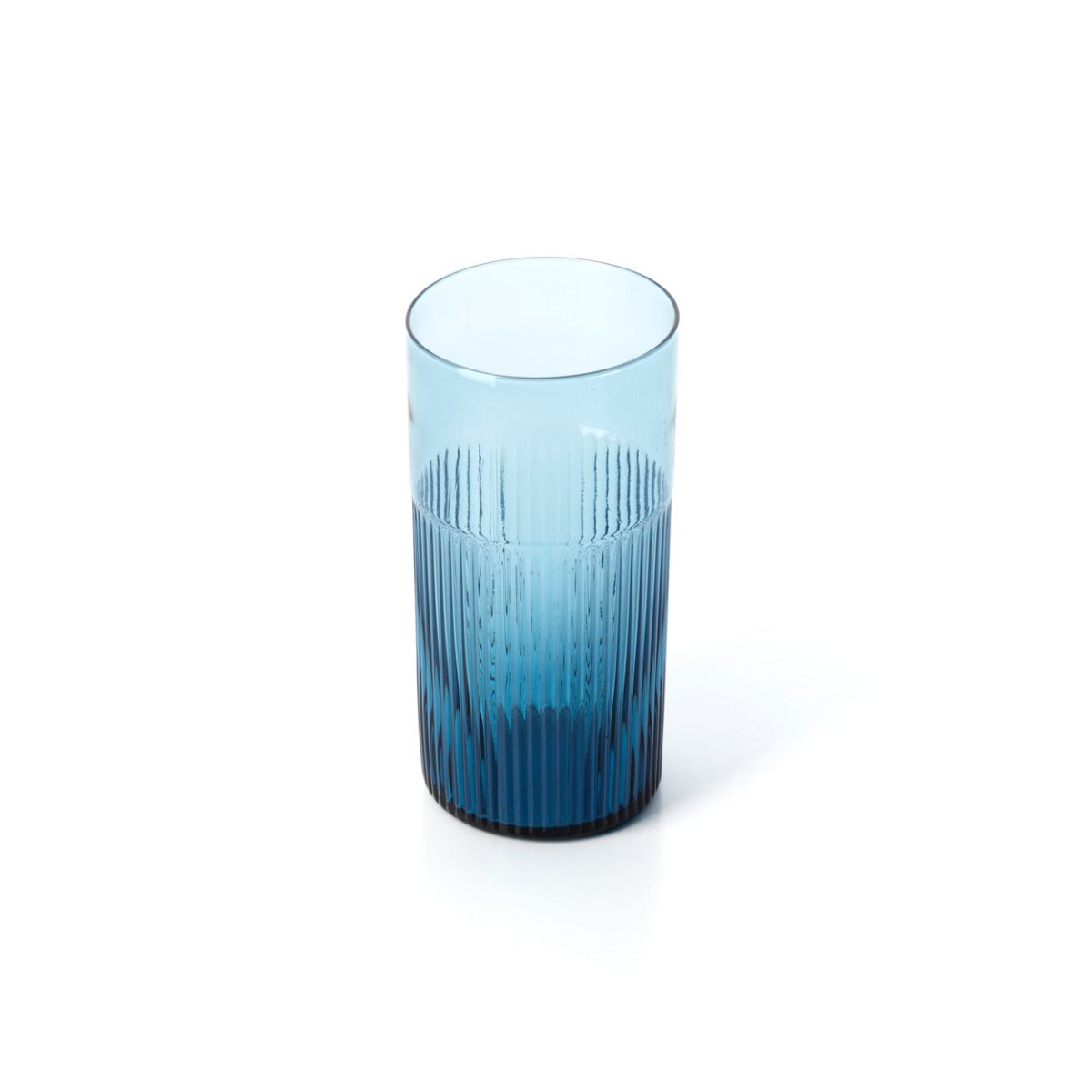 Blue glass tumbler with textured design on a white background