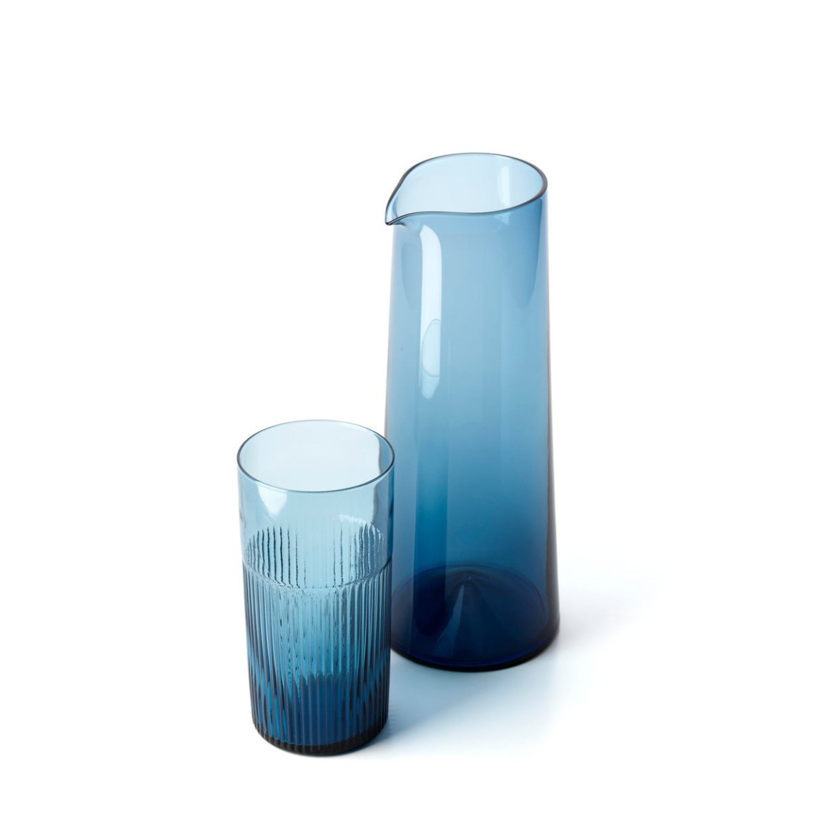 Two blue glass pieces, a tall vase and a cylindrical glass, on a white background