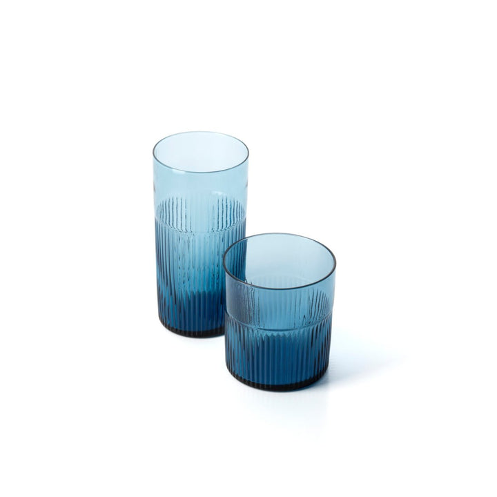 Two blue glass tumblers with textured design on a white background