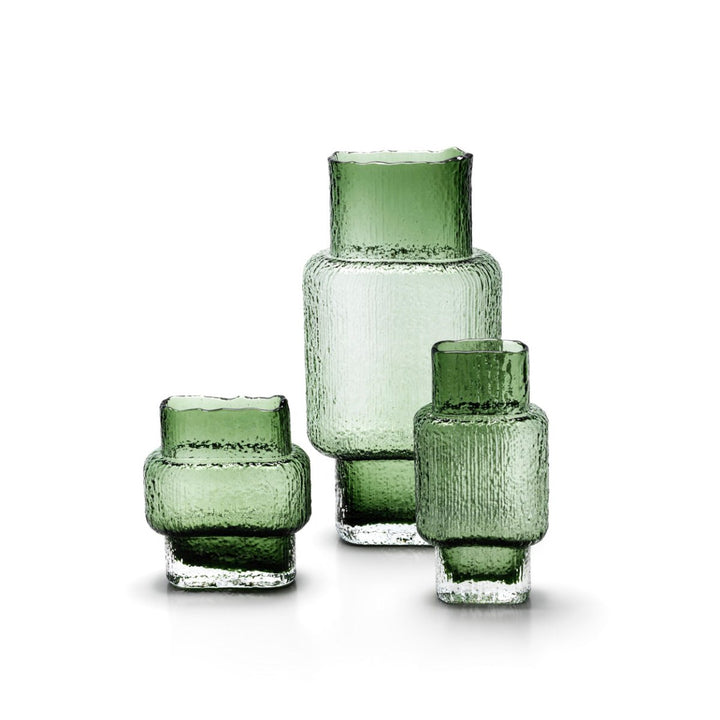 Set of three green glass vases on a white background