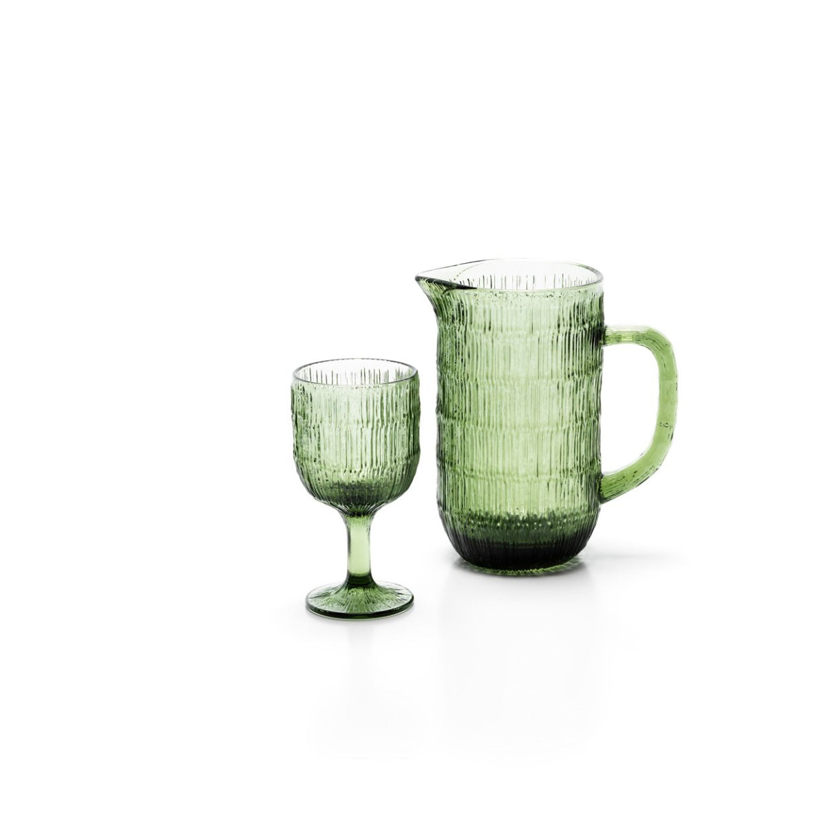 Green glass pitcher and goblet on a white background