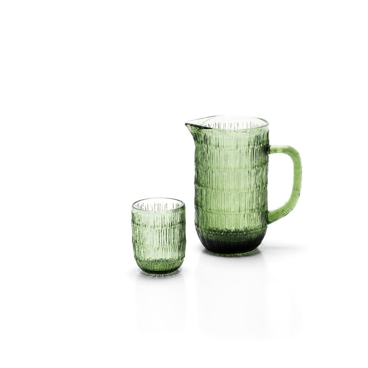 Green glass pitcher and cup on a white background