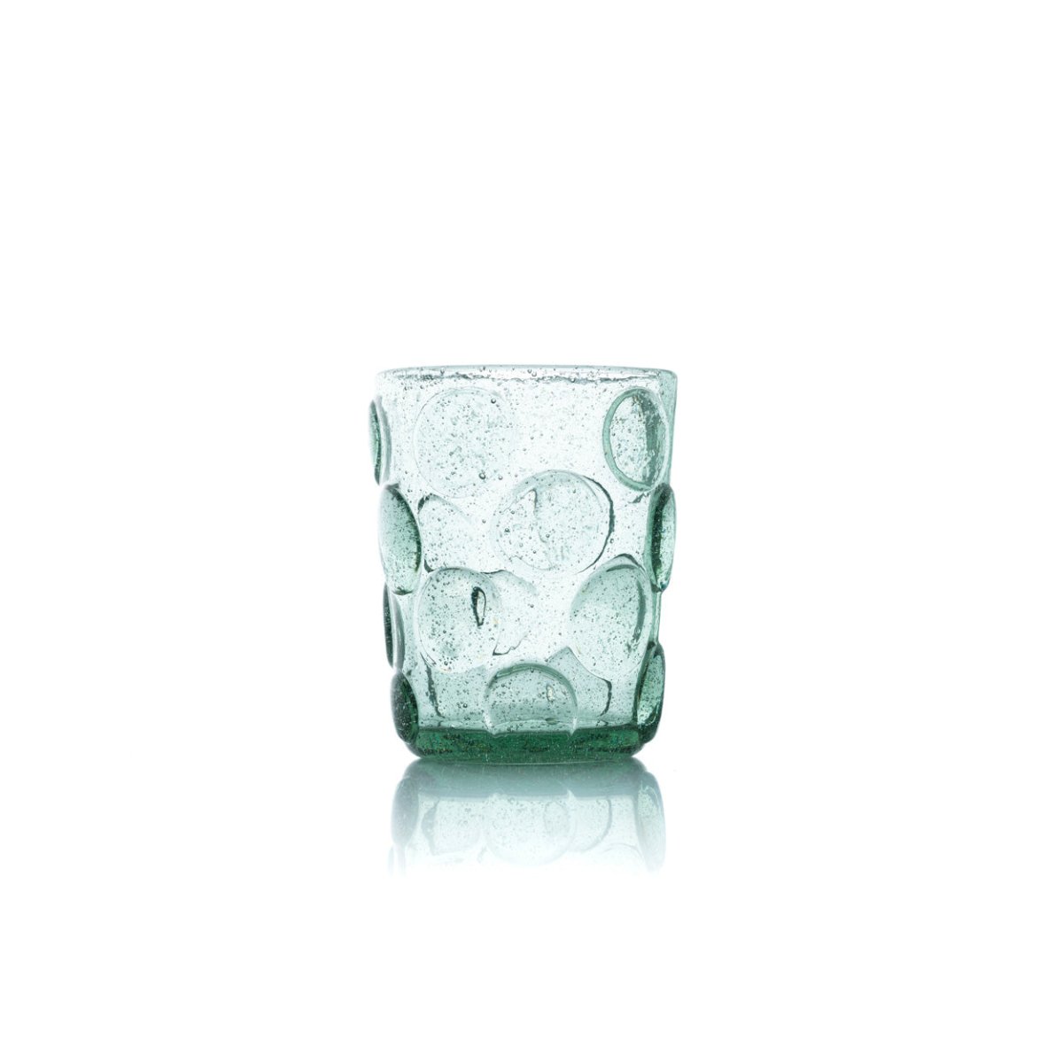 Green glass tumbler with bubble design on a white background