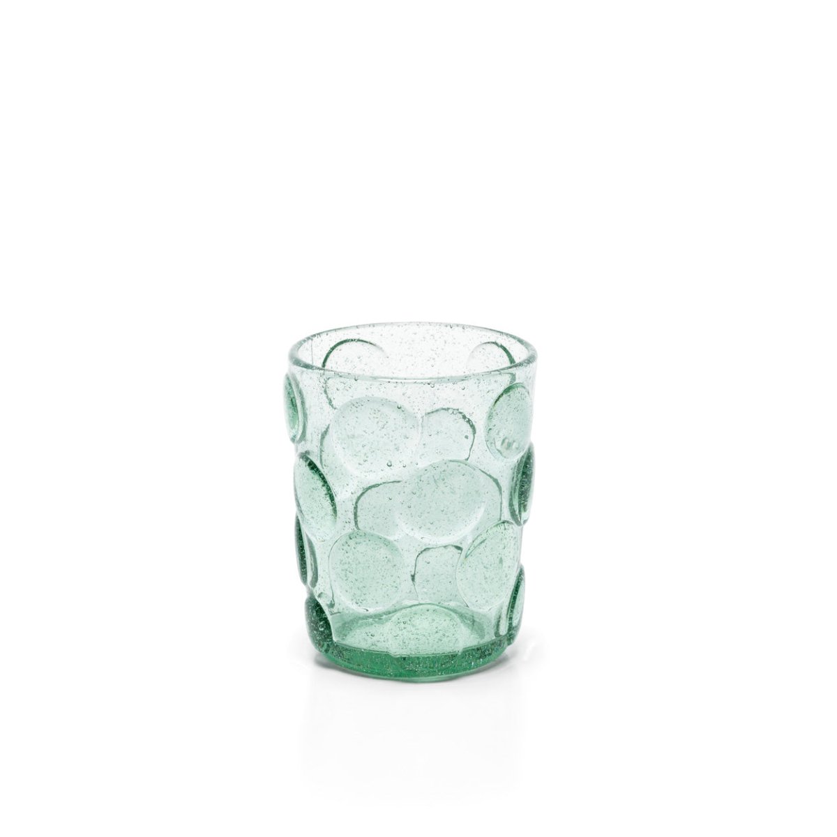 Green glass tumbler with bubble pattern on a white background