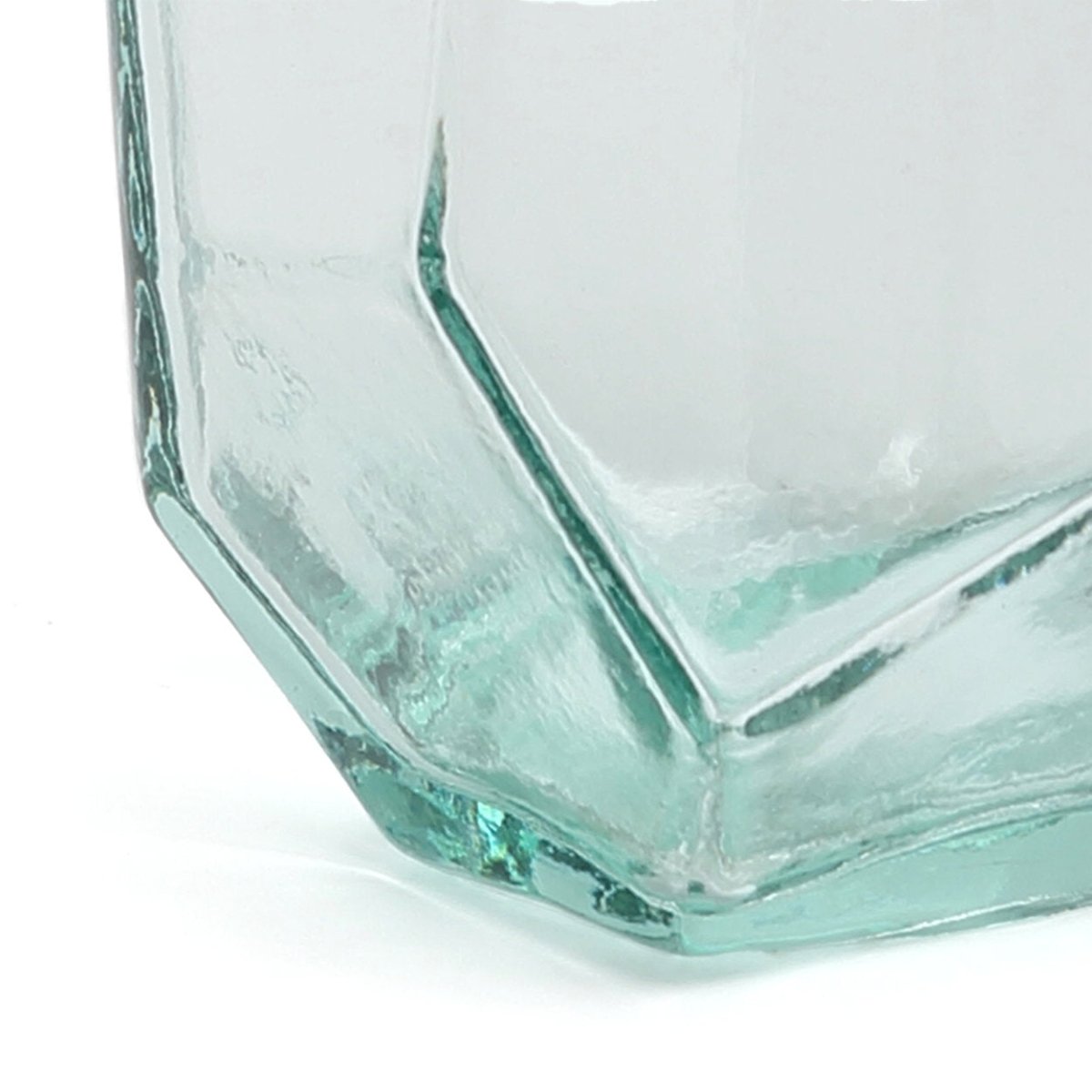 Hexagonal glass vase with a textured surface on a white background