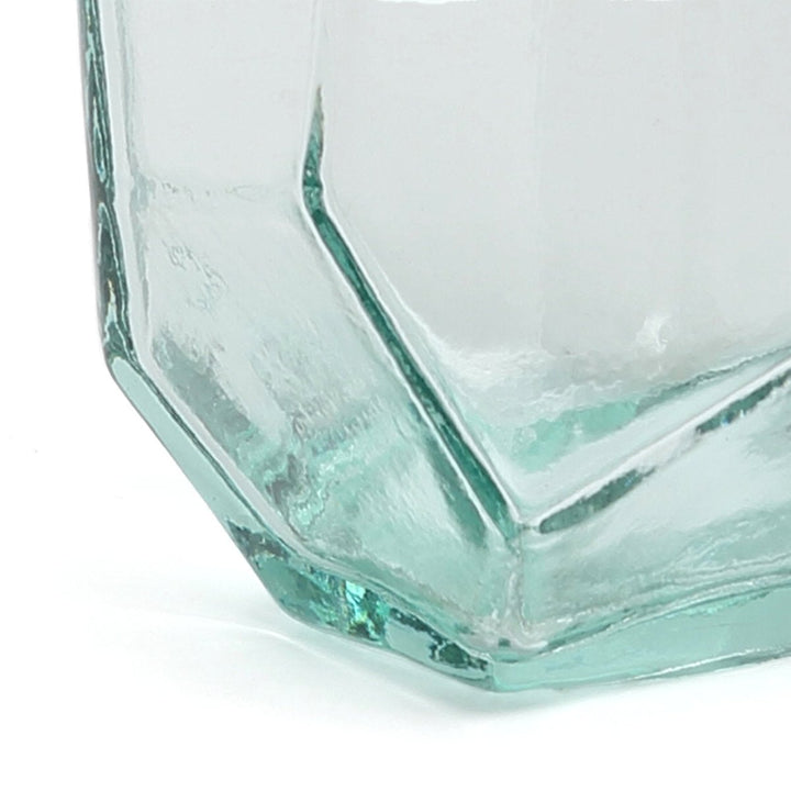 Hexagonal glass vase with a textured surface on a white background