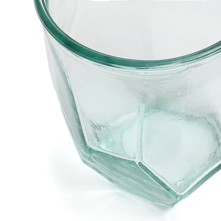 Clear glass container with geometric design on a white background