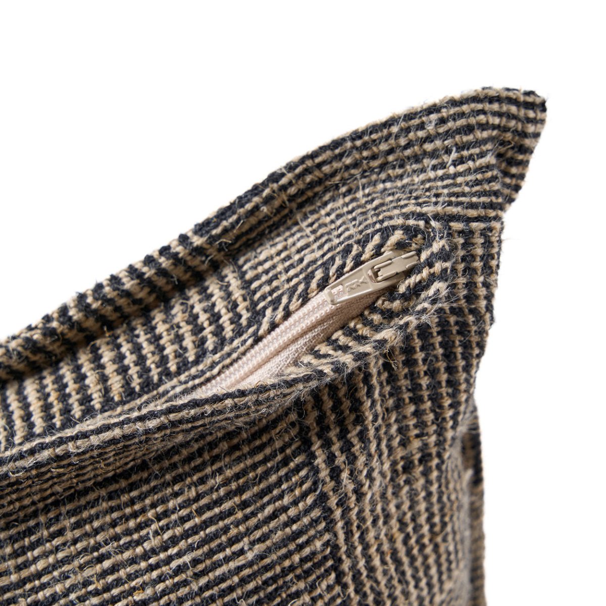 Close-up of a textured fabric with a zipper on a white background