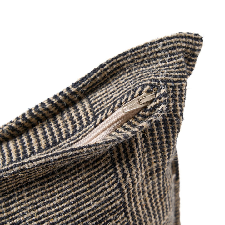 Close-up of a textured fabric with a zipper on a white background