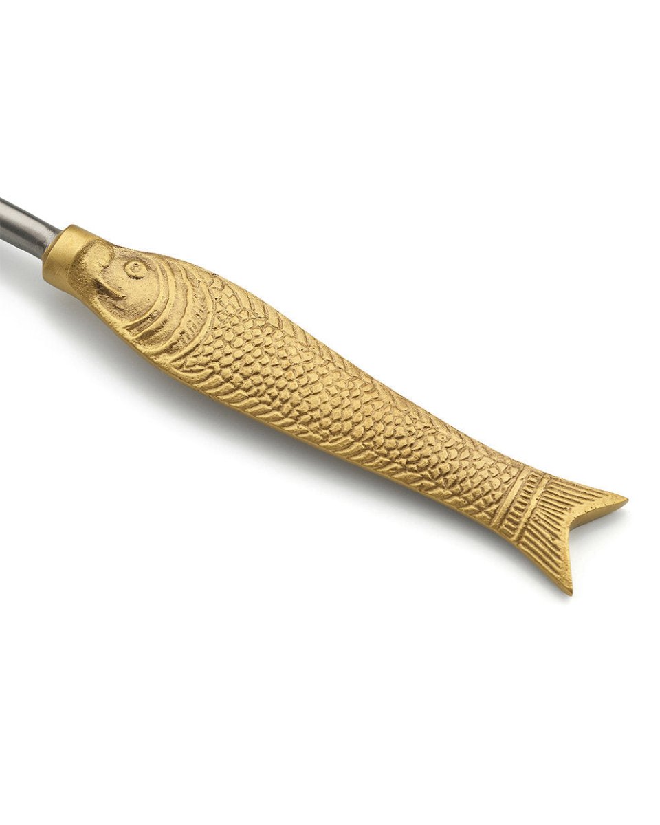 Gold fish-shaped tool on a white background