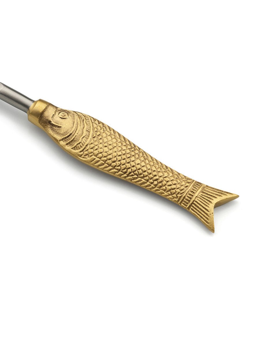 Gold fish-shaped tool on a white background