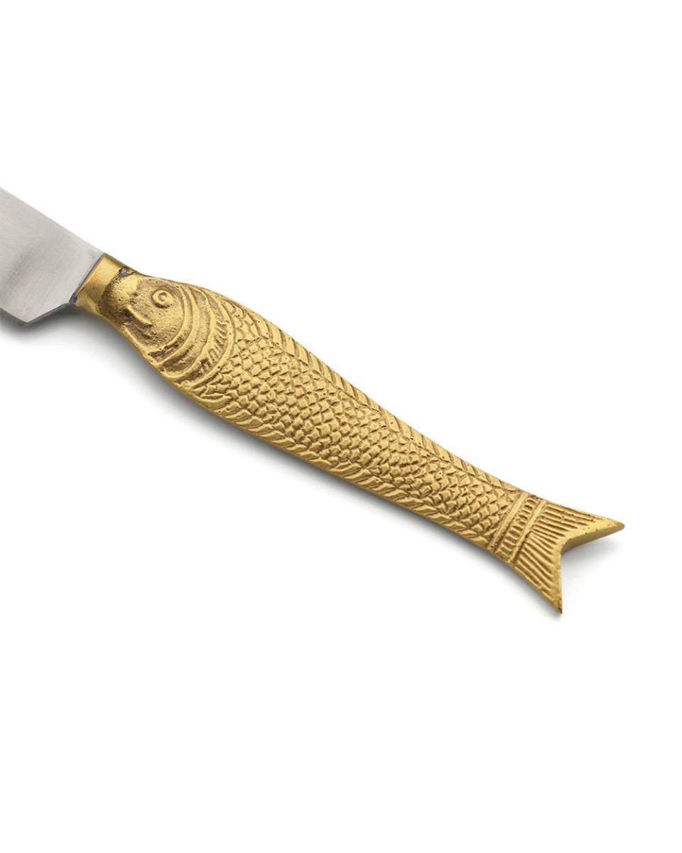 Gold fish-shaped knife handle on a white background