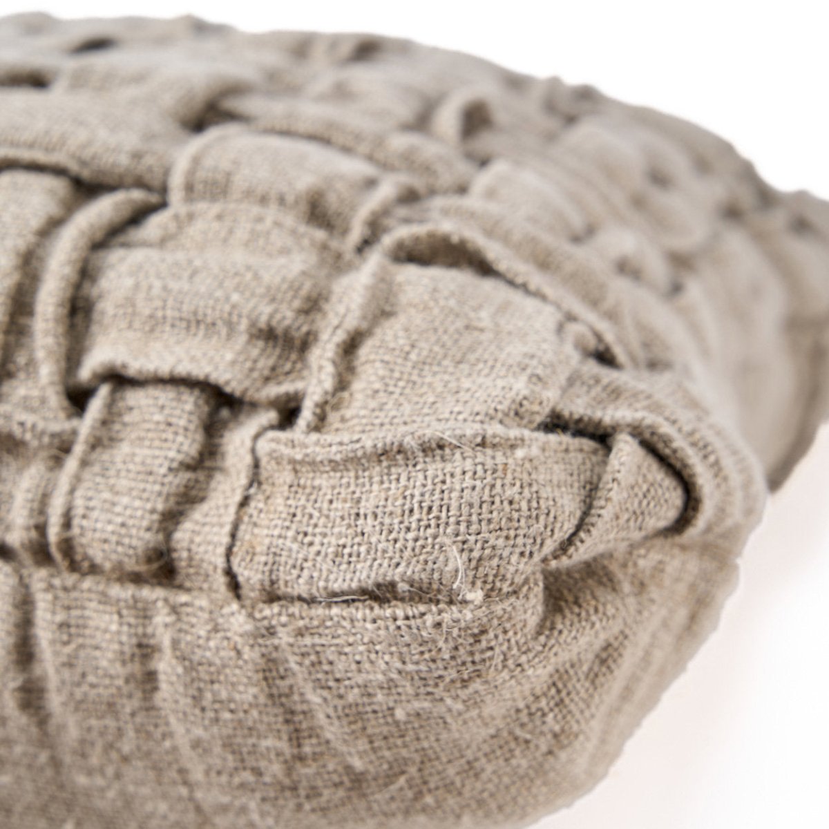 Close-up of a woven beige cushion on a white background