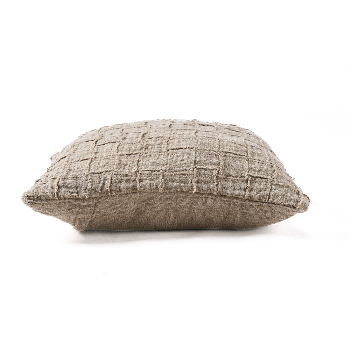 Textured beige pillow on a white background