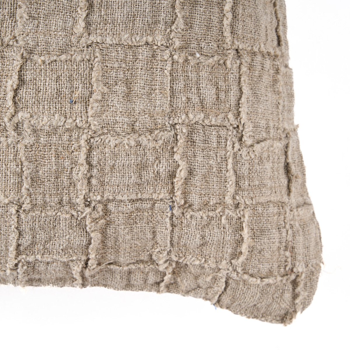 Textured beige fabric with a grid pattern on a white background