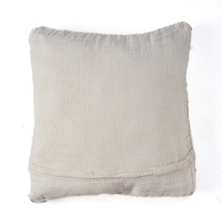 Textured beige pillow on a white background