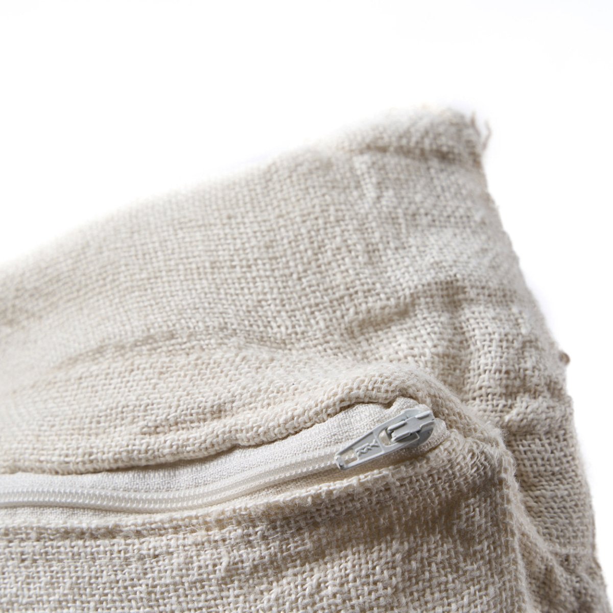 Close-up of a beige fabric bag with a zipper on a white background