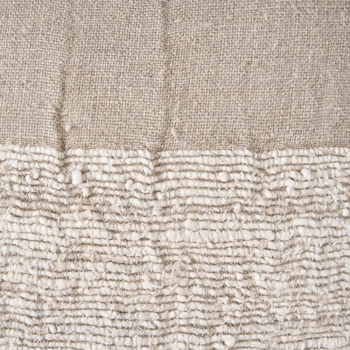 Close-up of textured beige fabric with a subtle pattern