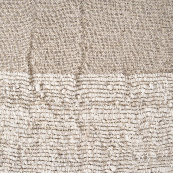 Close-up of textured beige fabric with a subtle pattern