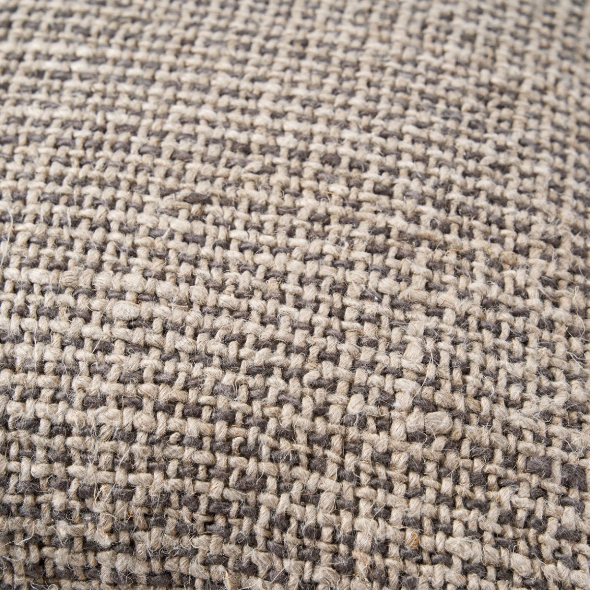 Close-up of a textured fabric with a checkered pattern in beige and brown.