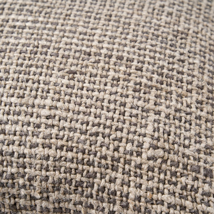 Close-up of a textured fabric with a checkered pattern in beige and brown.