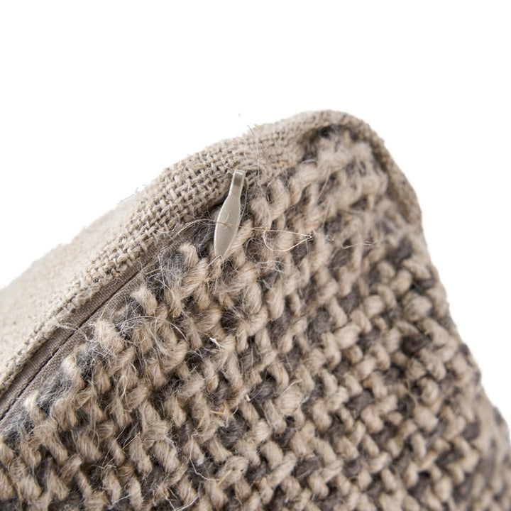 Close-up of a woven pouch with a zipper on a white background