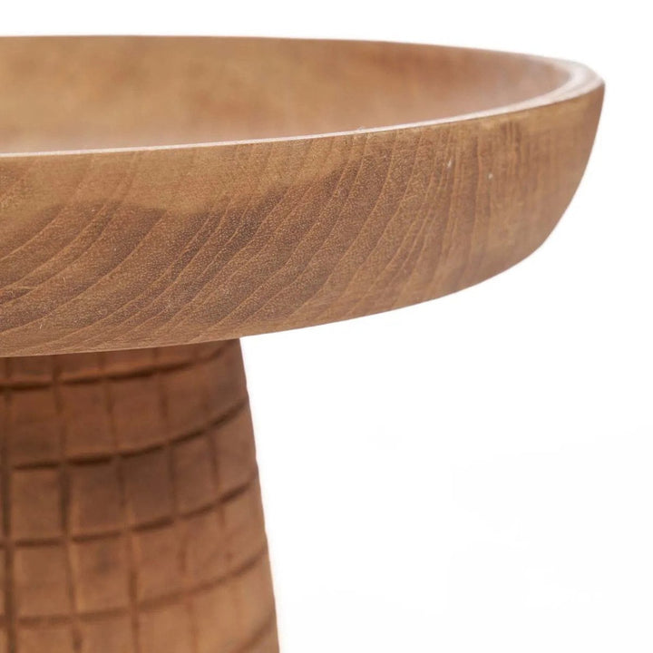 Wooden side table with a round top and textured base on a white background
