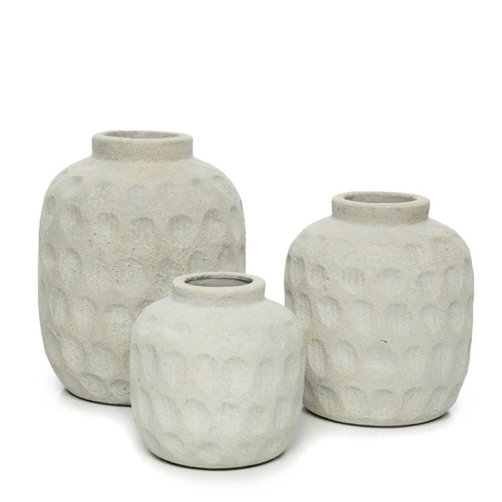 Three gray textured vases of different sizes on a white background