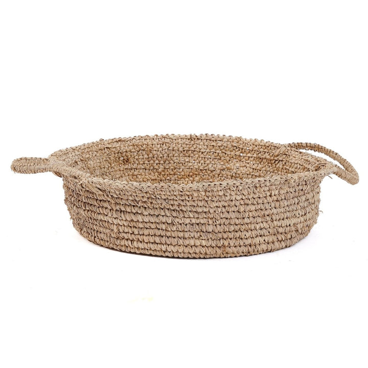 Woven basket with handles on a white background