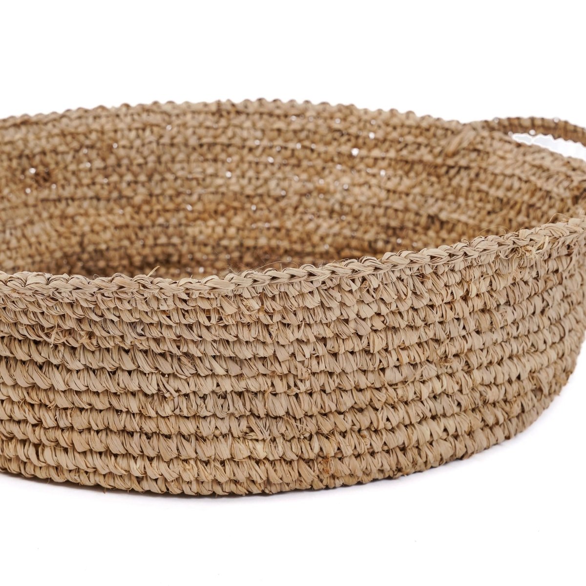 Woven jute basket on a white background