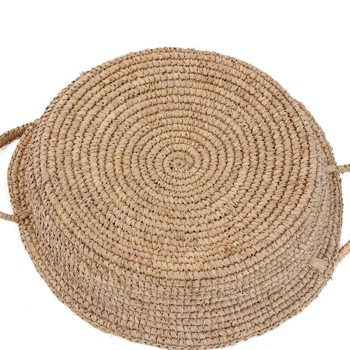 Back of round woven rattan basket on white background 