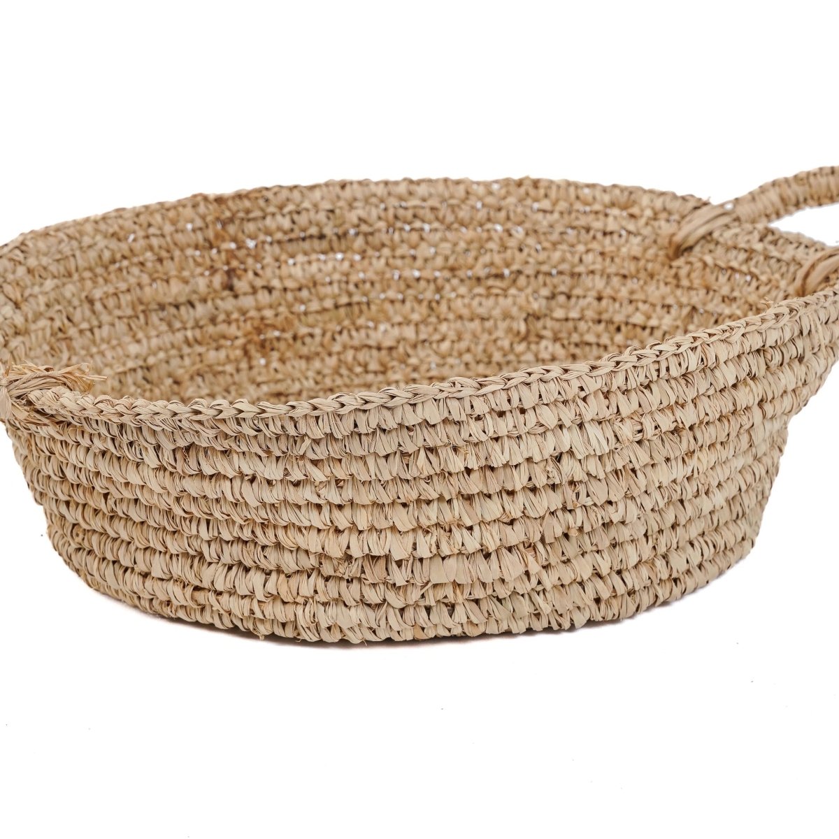 Woven basket with handles on a white background