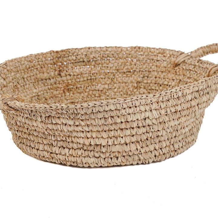 Woven basket with handles on a white background