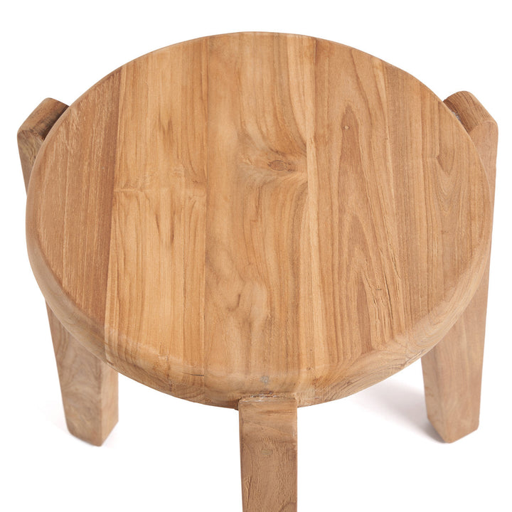 Wooden stool with a round seat and four legs on a white background