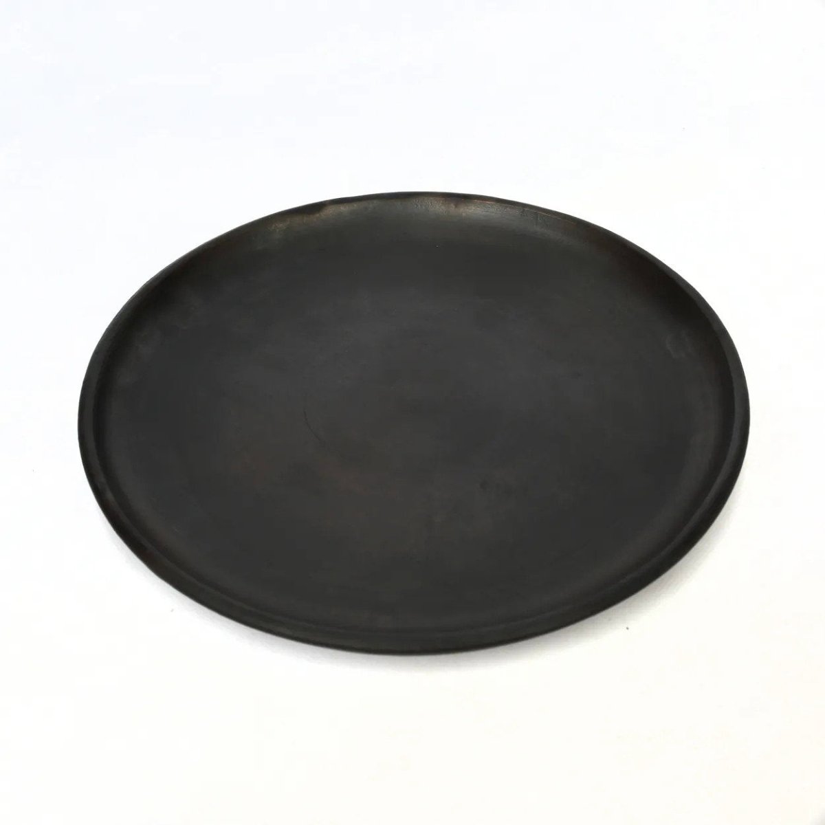 Black round plate on a white background