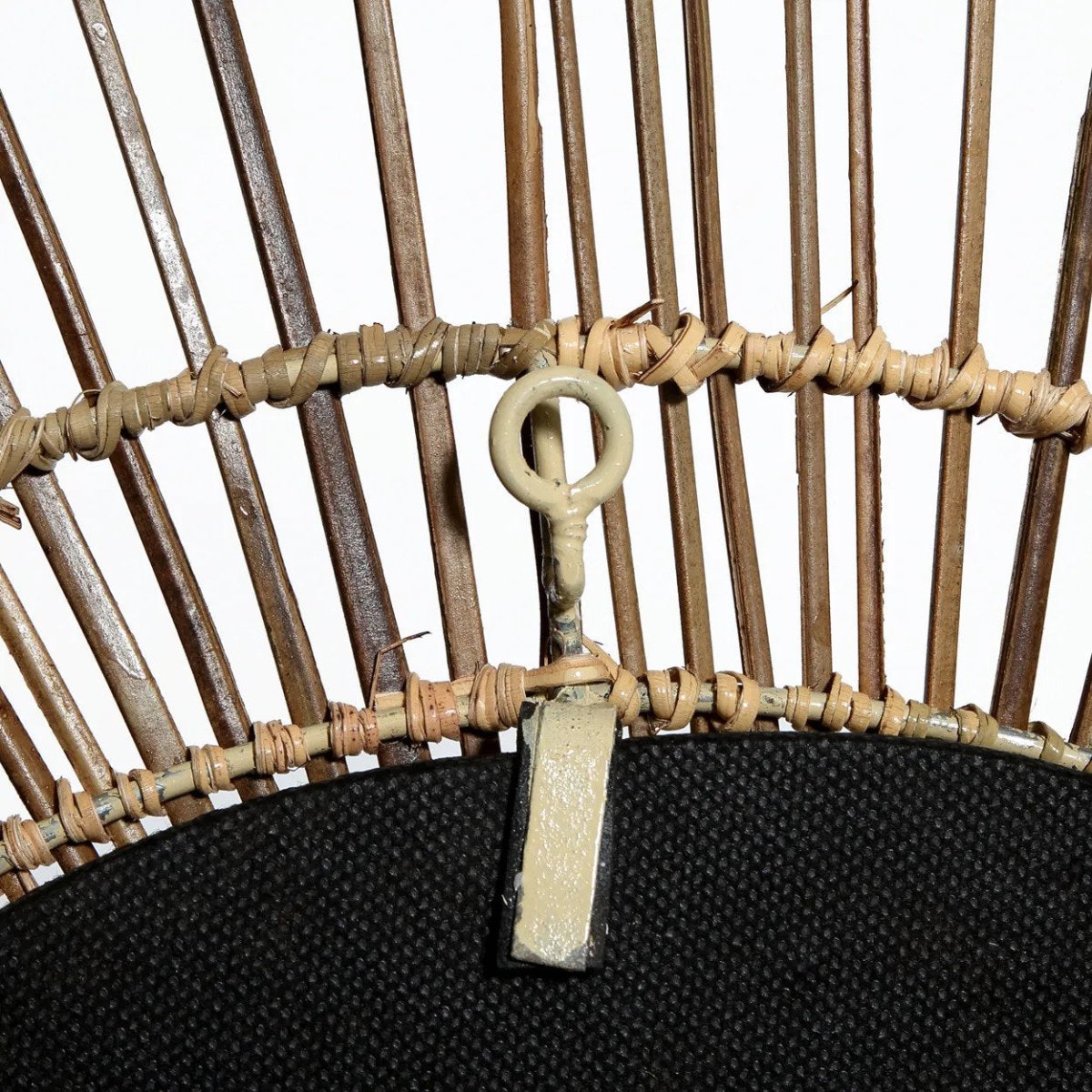 Close-up of a wicker basket with a key attached to it on a white background