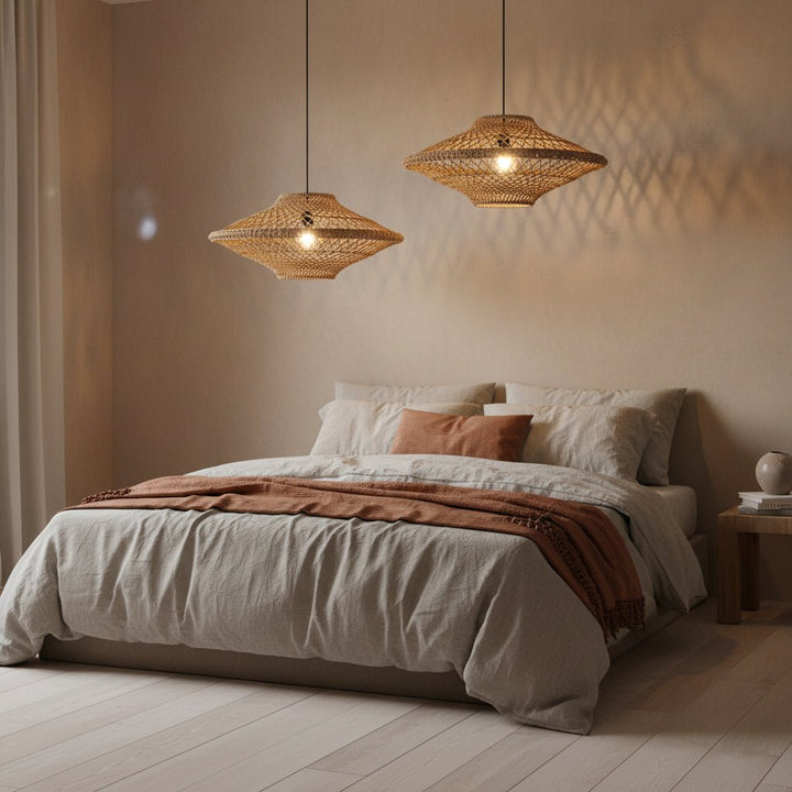 Bedroom with two woven pendant lights hanging above a bed with beige bedding.