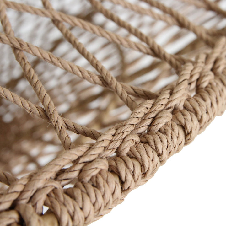 Close-up of a woven basket with natural fibers on a white background