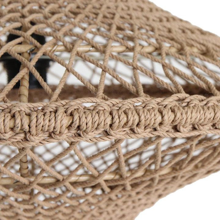 Close-up of a woven rope lamp with a textured pattern on a white background
