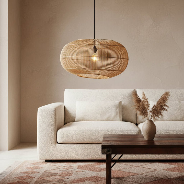 Beige sofa with a wooden coffee table and a woven pendant light in a living room.