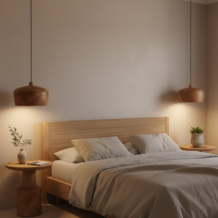 Modern bedroom with wooden bed, side tables, and pendant lights.