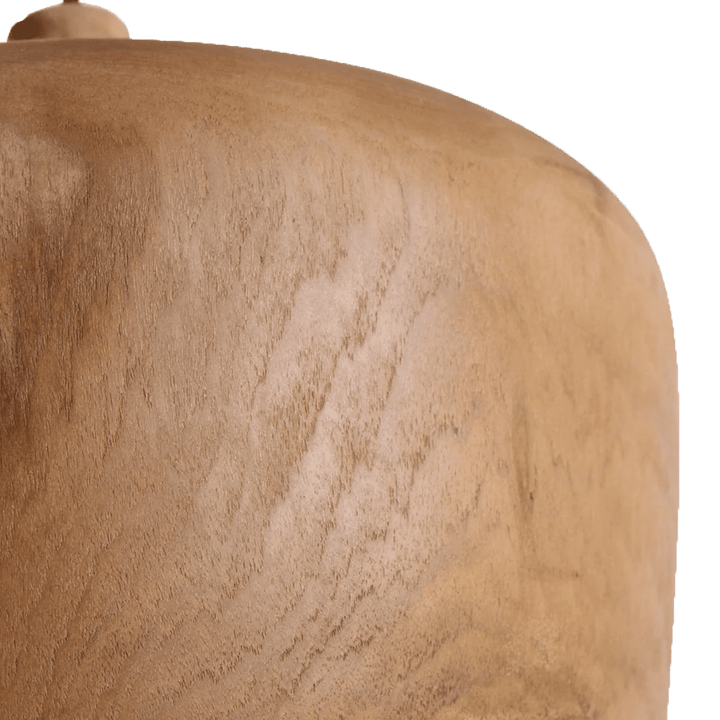 Close-up of a textured brown wooden lamp on a white background
