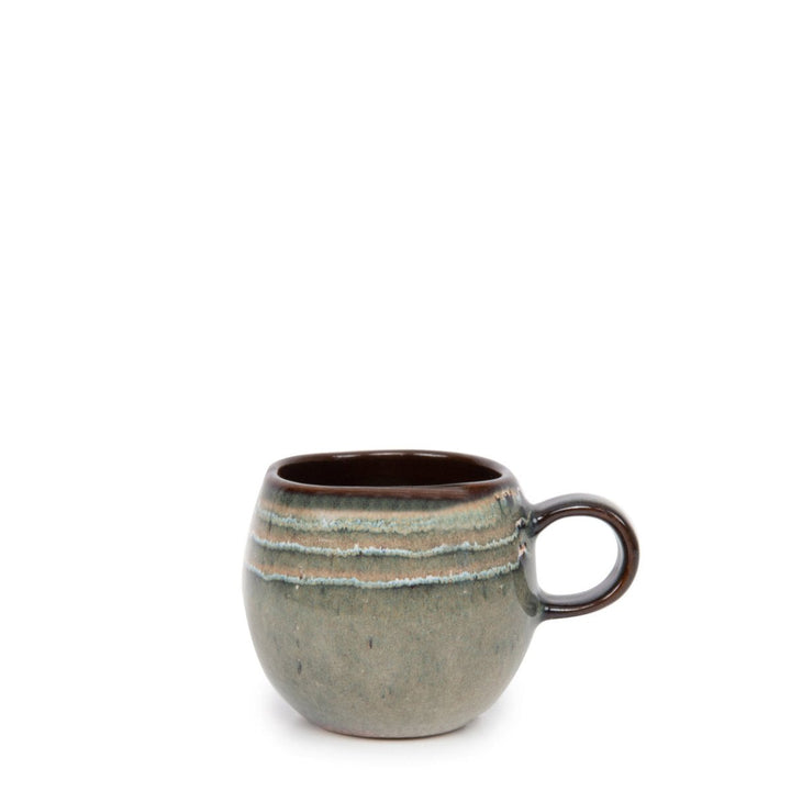 Ceramic mug with a textured surface and brown handle on a white background