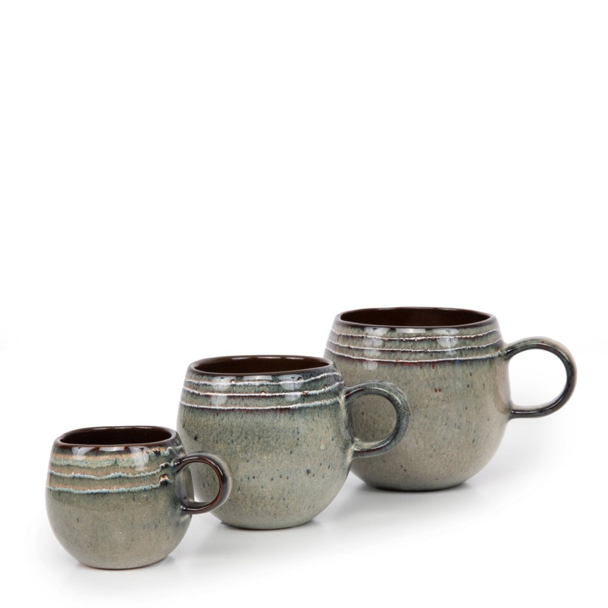 Three ceramic mugs with ribbed texture on a white background