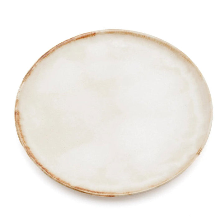 Round ceramic plate with a beige rim on a white background