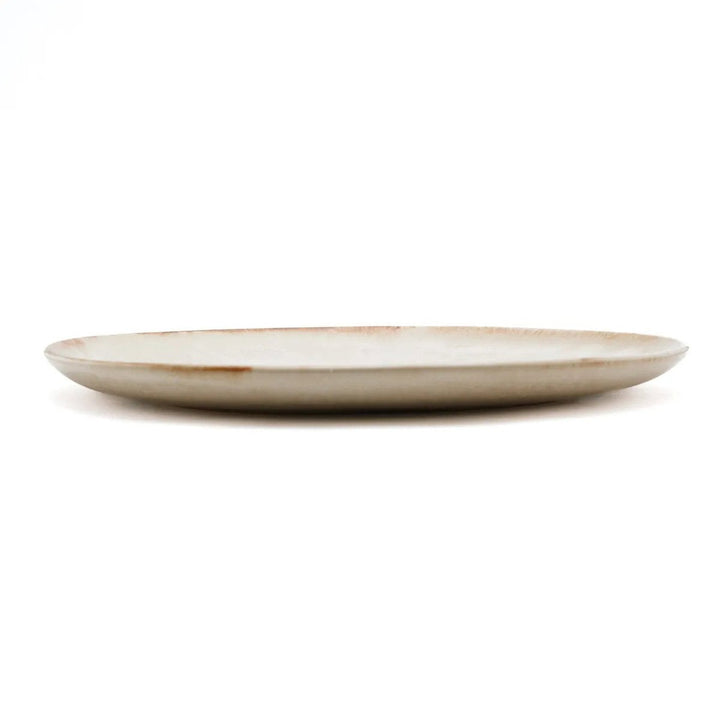 Beige ceramic plate on a white background