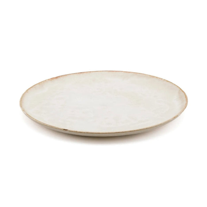 Round ceramic plate with a beige rim on a white background